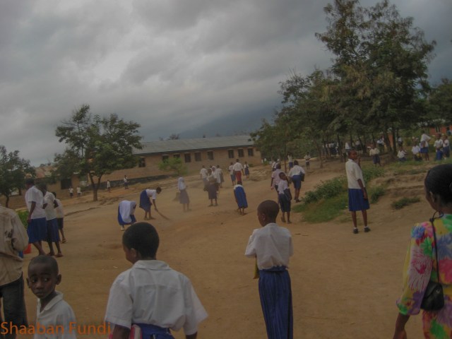 Pupils sweeping the ground in the morning